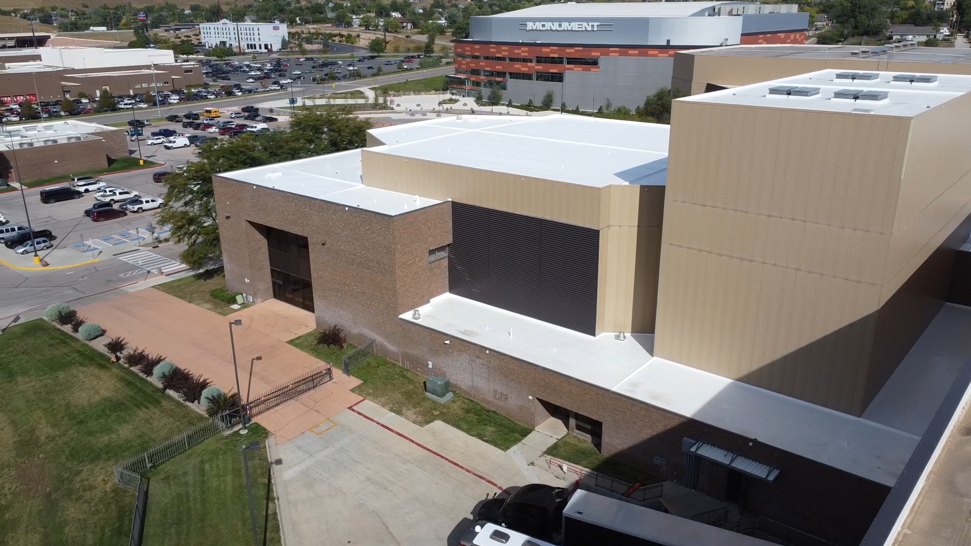 Aerial view of the completed white silicone restoration across the stepped roof levels at The Monument in Rapid City, South Dakota